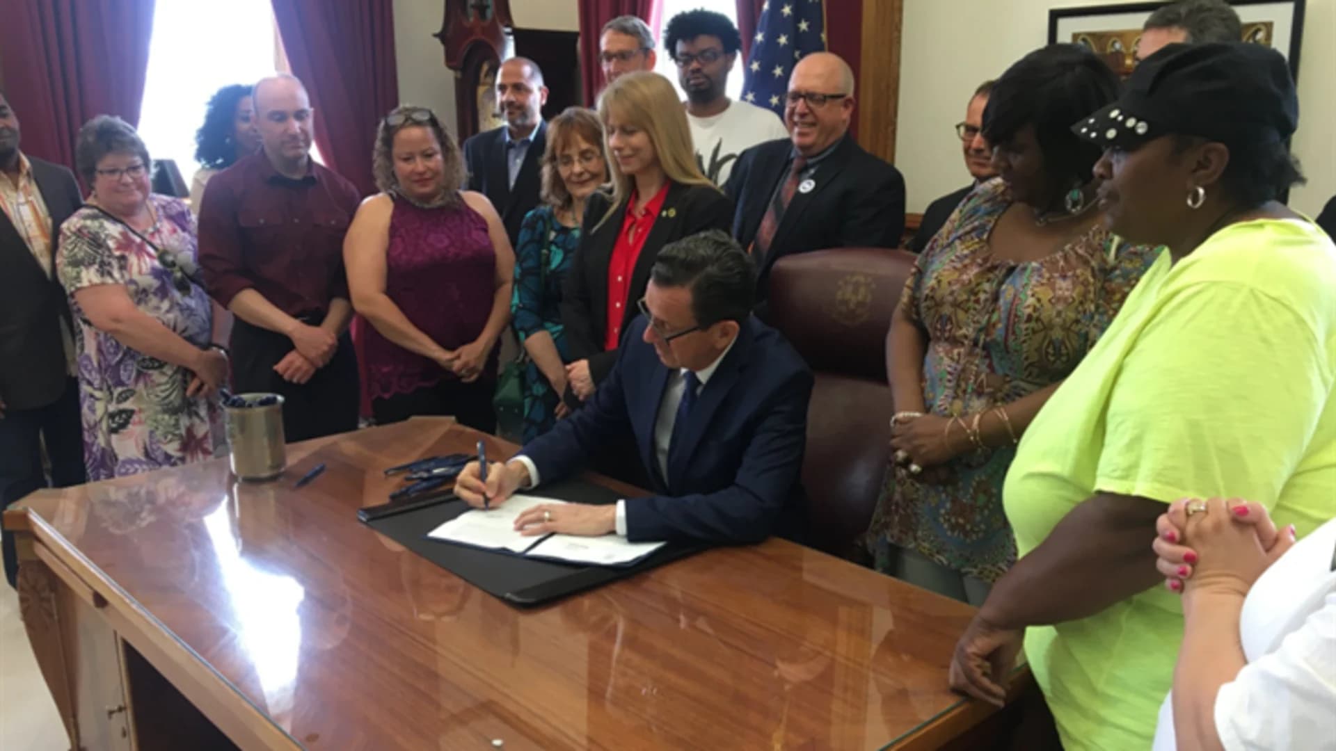 Malloy signs wage increase for caretakers of people with intellectual disabilities